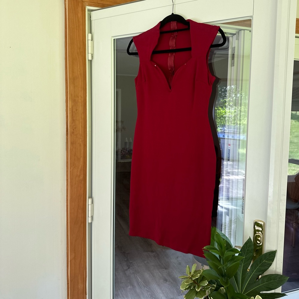 Burgundy, form fitting midi dress with a sweetheart neckline detail.